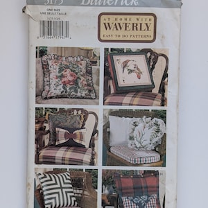 May include: A vintage Butterick sewing pattern featuring various pillow designs. The pattern includes images of pillows with floral, plaid, and geometric patterns. The text on the pattern reads "At Home With Waverly, Easy to Do Patterns."