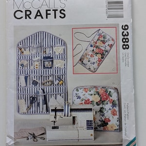 May include: A McCall's Crafts 9388 sewing pattern envelope featuring illustrations of a blue and white striped wall organizer, a floral print hanging pouch, and a floral print sewing machine cover, with a barcode and text on the front.
