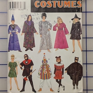 May include: A Simplicity Costumes sewing pattern envelope, number 0673, featuring illustrations of ten different costume designs labeled A through J, including a wizard, a clown, a bat, and various robes, with size information S, M, L printed on the front.