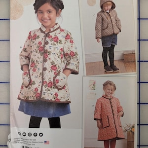 May include: A Simplicity 8305 sewing pattern envelope for children's sizes 3-8. The front displays three variations of a quilted coat with brown trim, including a floral print, a polka dot hooded version, and a solid coral-colored design.
