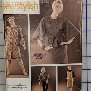 May include: A Simplicity sewing pattern envelope, number 3631, featuring illustrations of garments including a brown jacket with a tie waist, a patterned long coat, and a tan dress. The text includes Simplicity, sewstylish, and American Sewing Guild.