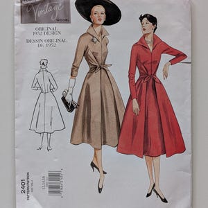 May include: Vintage Vogue Model sewing pattern featuring an original 1952 design. The cover art depicts two women in elegant dresses, one in tan and the other in red. The pattern includes a drawing of the dress from the back and the pattern number 2401.