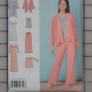 May include: Simplicity easy-to-sew pattern 1720A. The package features a woman wearing a coral-colored outfit, including a jacket and pants. The pattern includes various garment designs, such as a wrap top, dress, and pants. The size range is XXS-XXL.