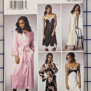 May include: Vogue Patterns sewing pattern featuring a pink satin robe, floral print robe, and various lingerie designs. The pattern number is V9015, size A5 (6-8-10-12-14). The Vogue Patterns logo is visible.