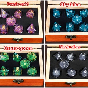 May include: Four wooden boxes containing different coloured dice sets. The boxes are labelled "Purple-gold", "Sky-blue", "Grass-green", and "Black-silver". Each box contains a set of dice with different colours and numbers.