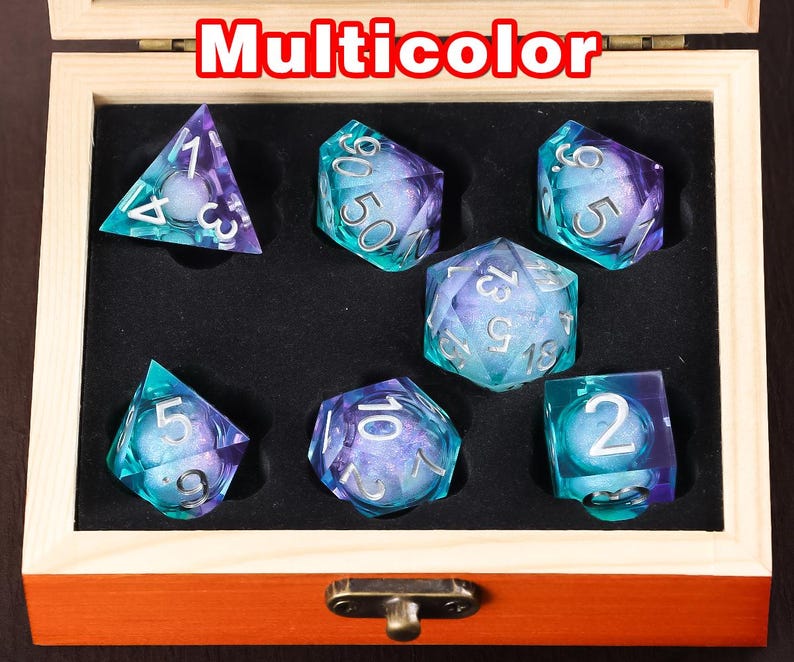 May include: A set of seven iridescent dice in a wooden box. The dice are multi-coloured with a blue and purple swirl pattern. The box is labelled "Multicolor".