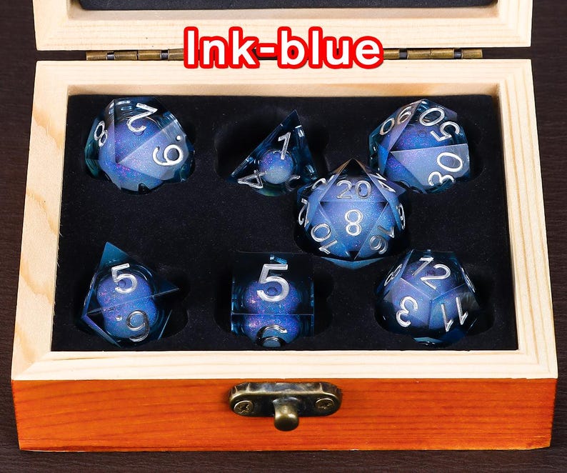 May include: A set of seven blue dice with silver numbers and a glittery finish. The dice are in a wooden box with a brass latch. The box is labelled "Ink-blue".