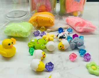 May include: A set of colorful slime in clear jars with a variety of small toys, including chicks, a frog, a cow, and an elephant. The slime is in different colors, including green, yellow, pink, and blue. The toys are made of plastic and are in various colors.