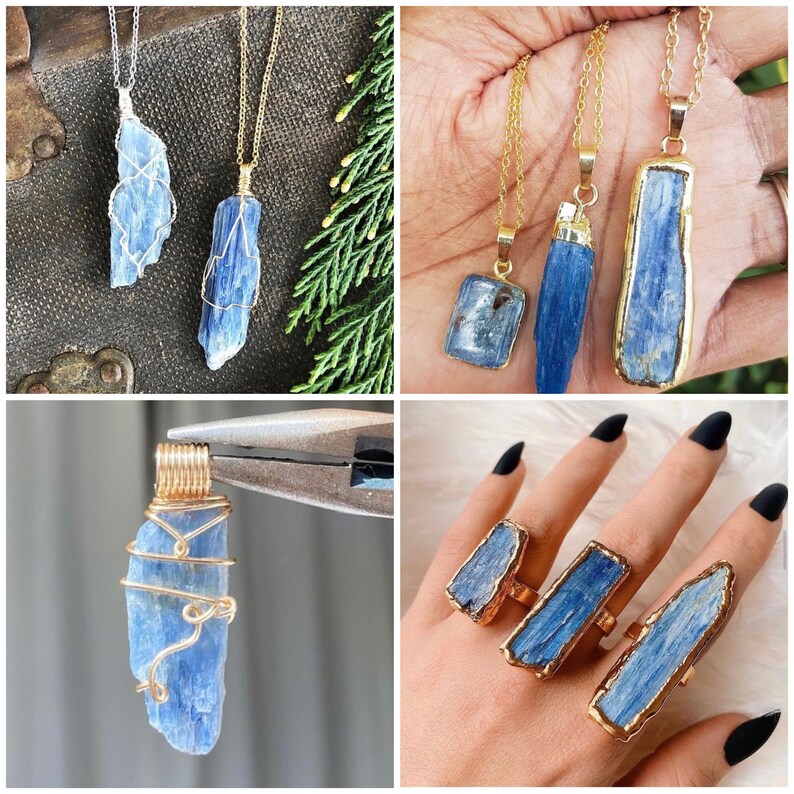 May include: Three gold necklaces with blue kyanite crystal pendants. The pendants are different shapes and sizes. The necklaces are on a wooden surface with green foliage.