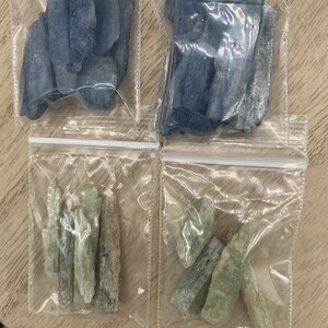 May include: Four bags of blue and green crystals. The bags are clear plastic and the crystals are in various shapes and sizes.