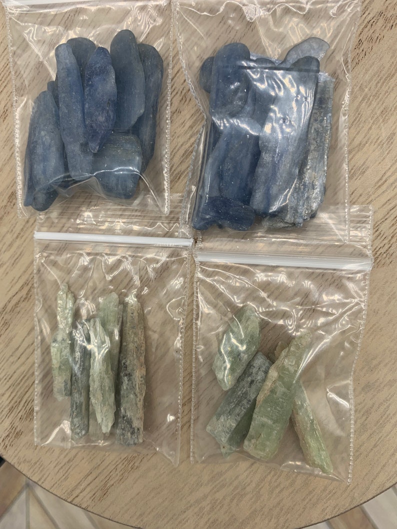 May include: Four bags of blue and green crystals. The bags are clear plastic and the crystals are in various shapes and sizes.