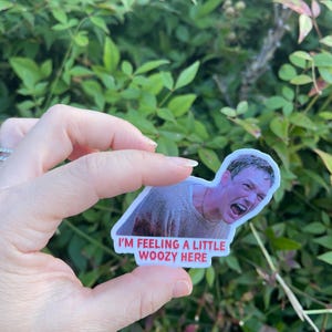 May include: A white sticker with a photo of a man with a shocked expression. The sticker has red text that says "I'm feeling a little woozy here."