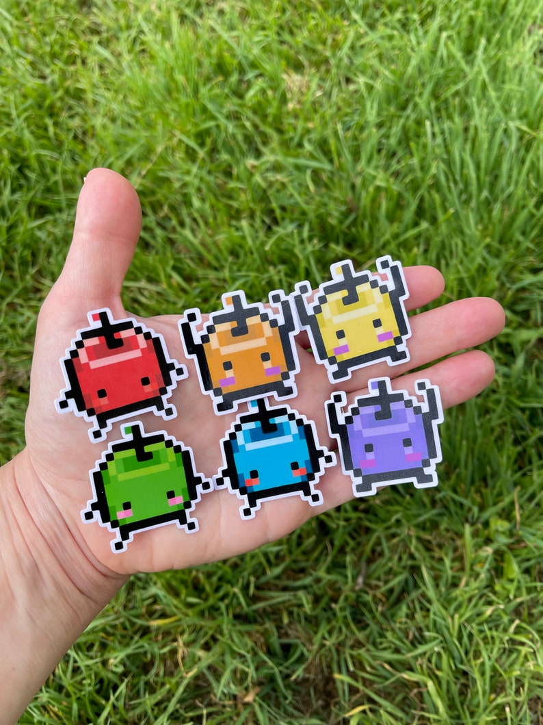 May include: Seven colourful pixelated character stickers with different facial expressions. The characters are red, orange, yellow, green, blue, purple, and white.