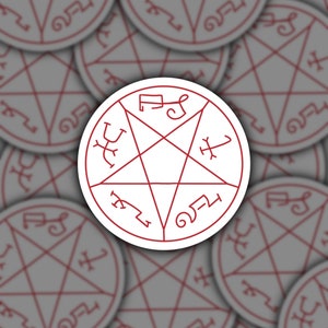 May include: A white sticker with a red pentagram and symbols around the perimeter. The pentagram has a symbol in each point and a symbol in the center.