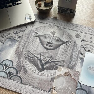 Hathor desk mat in use during a tarot card reading session on a wooden table. This sacred mat enhances spiritual practices, promotes emotional healing, and connects you to the divine feminine energy of Hathor.