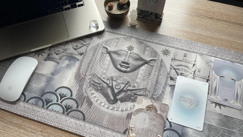 Hathor desk mat in use during a tarot card reading session on a wooden table. This sacred mat enhances spiritual practices, promotes emotional healing, and connects you to the divine feminine energy of Hathor.