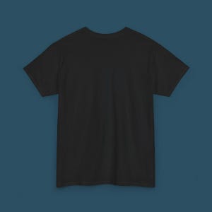 May include: A solid black t-shirt with short sleeves. The shirt is made of a soft material and is displayed on a blue background. The t-shirt is a basic wardrobe staple.