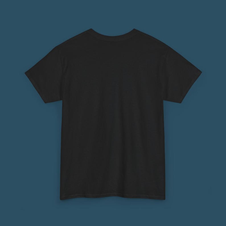 May include: A solid black t-shirt with short sleeves. The shirt is made of a soft material and is displayed on a blue background. The t-shirt is a basic wardrobe staple.