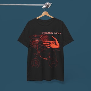 May include: Black t-shirt with a red and white graphic of a hand reaching towards a sphere with the text "noise unit" above it.
