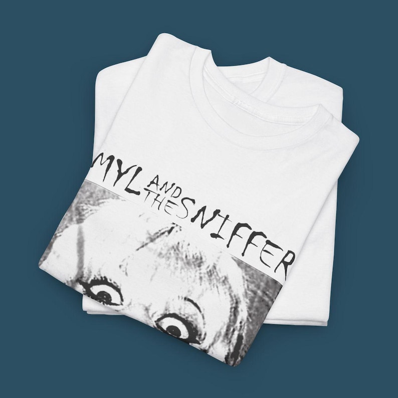 May include: White t-shirt with a black and white image of a woman's face and the text "Amyl and the Sniffers" printed on the front.