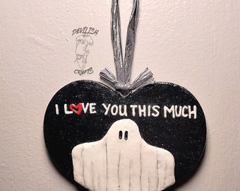 May include: Black heart-shaped ornament with a white ghost and the text "I love you this much" in red.