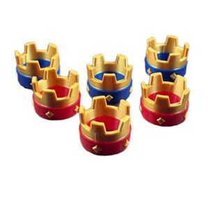 May include: Six miniature crown figurines. The crowns have a gold-colored top and a base in either red or blue. The red crowns have gold diamond accents. The blue crowns have gold diamond accents. The crowns are likely for a game or craft project.