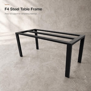 May include: A black F4 Steel Table Frame with a rectangular design featuring four vertical legs and a horizontal support structure. The text F4 Steel Table Frame and Three-rail support for demanding tabletops is visible in the upper left corner.