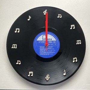 Unique vinyl record wall clock, with musical notes for numbers, crafted from an original 12” vinyl record, fully assembled ready to hang