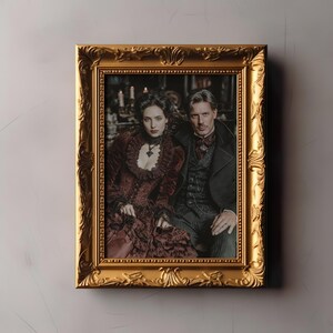 May include: A framed portrait featuring a man and woman in Victorian-era attire. The woman wears a burgundy dress with lace details, and the man is in a dark suit. The ornate gold frame adds a touch of elegance to the image.