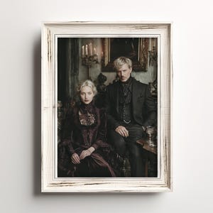May include: A framed portrait featuring a man and a woman in Victorian-era attire. The woman wears a dark burgundy velvet dress with lace detailing, while the man is in a black suit. The frame is white with a distressed finish, adding a vintage aesthetic.