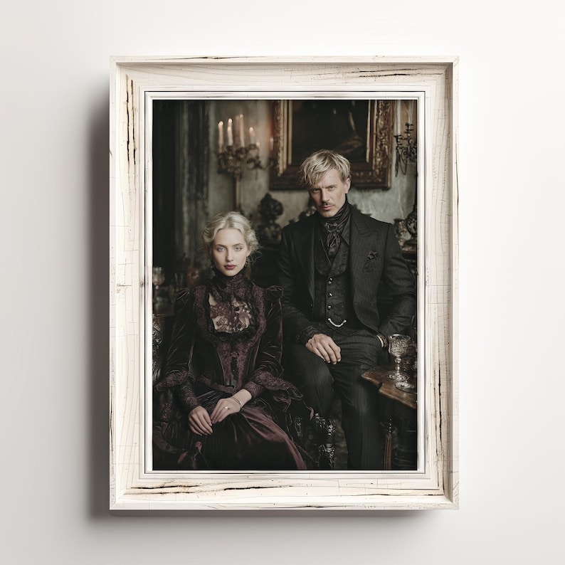May include: A framed portrait featuring a man and a woman in Victorian-era attire. The woman wears a dark burgundy velvet dress with lace detailing, while the man is in a black suit. The frame is white with a distressed finish, adding a vintage aesthetic.