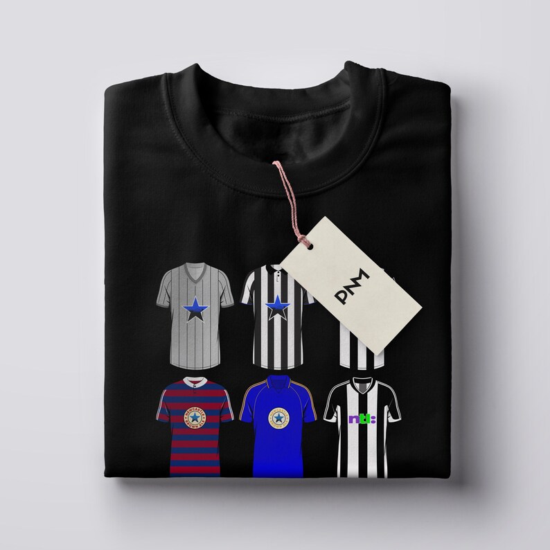 Pu&ograve; includere: Felpa nera con sei maglie da calcio con vari disegni. Le maglie presentano strisce, stelle e loghi di squadre in colori come blu, rosso e nero. Un'etichetta con le lettere "PNM" &egrave; appesa alla felpa.