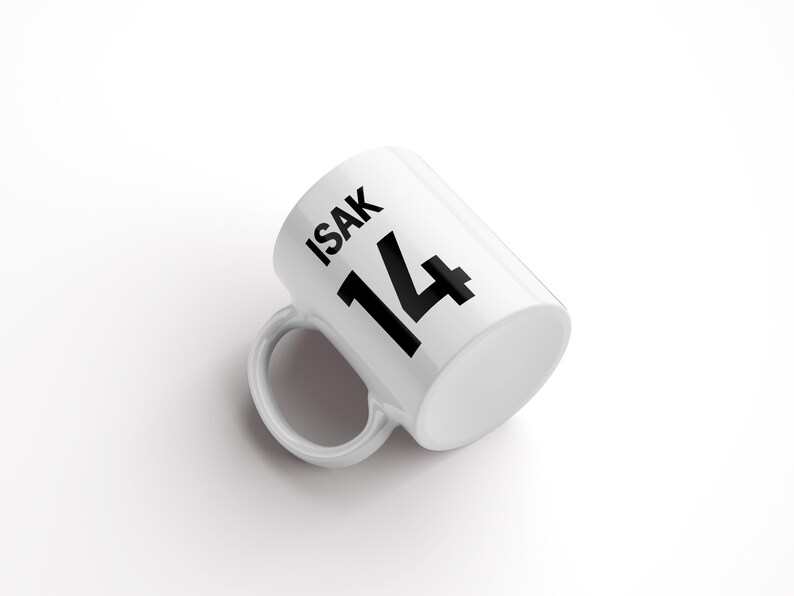 May include: White ceramic mug with black text that reads "ISAK 14".