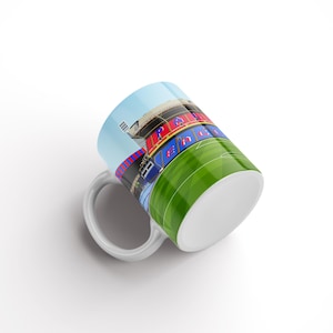 May include: White ceramic mug featuring a colourful illustration of a stadium with the words "Park Head" printed on the side.