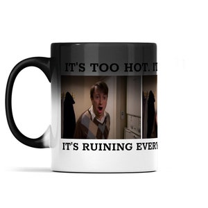 May include: A black and white color-changing mug with a picture of a man with a surprised expression. The text on the mug reads "It's too hot. It's ruining everything."