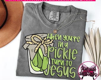 May include: A gray t-shirt with a graphic of a pickle jar and the text "When you're in a pickle turn to Jesus".