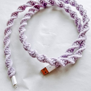 May include: A purple braided cord with a white USB connector on one end and a white lightning connector on the other end.
