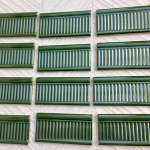 12 green Art nouveau style border tiles. Glazed NEW ceramic embossed tiles. Combine with other wall art tiles on a backsplash or border