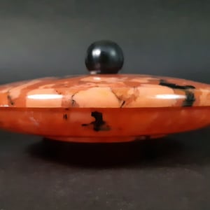 Spectacular large celluloid round box moulded in translucent orange ,brown and black marbled material