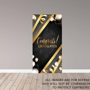 May include: Black and gold graduation backdrop with the text "Congrats! Graduates" and white pearl-like decorations.