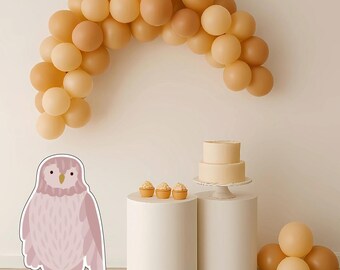 May include: A party scene featuring a balloon arch in tan and peach hues. A two-tiered cake and cupcakes are displayed on white pedestals. A large owl cutout is in the foreground. Additional balloons are clustered on the floor.