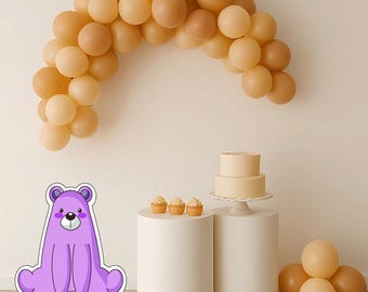 May include: A party scene featuring a balloon arch in tan and beige hues. A two-tiered cake and cupcakes are displayed on white pedestals. A purple bear sticker is in the foreground. Balloons are clustered on the right.