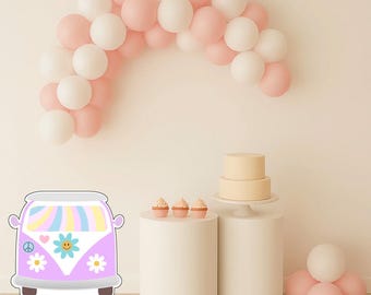 May include: A party scene with a pink and white balloon arch. A lilac van with a peace sign and flower design is in the foreground. Two white pedestals hold a cake and cupcakes. Additional pink and white balloons are scattered around.