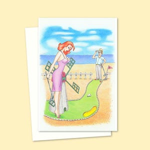 クレイジーゴルフのグリーティングカード。手描きの海辺のポストカード風イラスト付き。内側は空白で、独自のメッセージを書き込めます。