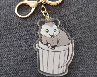 Schattige opossum-sleutelhanger