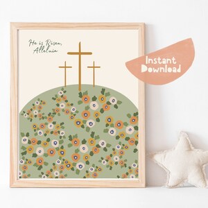 K&ouml;nnte beinhalten: Ein druckbarer Kunstdruck mit einem gr&uuml;nen H&uuml;gel, drei braunen Kreuzen und dem Text "He is Risen, Alleluia". Der H&uuml;gel ist mit kleinen orangefarbenen, gelben und wei&szlig;en Blumen bedeckt.
