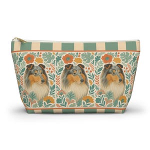 May include: A zippered cosmetic bag featuring a repeating pattern of a Collie dog portrait, surrounded by floral and leaf designs in orange, yellow, and green. The top has a striped pattern in green and beige.