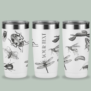 May include: Three white stainless steel tumblers with black insect illustrations. The center tumbler has the text "YOUR TEXT" printed on it.