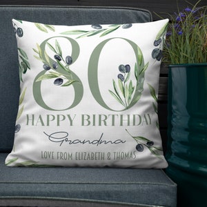 May include: White throw pillow with green watercolor olive branches and the number 80 in green. The text "Happy Birthday Grandma Love from Elizabeth & Thomas" is printed on the pillow.