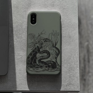 May include: A sage green phone case featuring a detailed black illustration of a snake coiled among tropical plants. The design is a detailed, vintage-style botanical illustration. The phone case is made of a smooth, matte material.